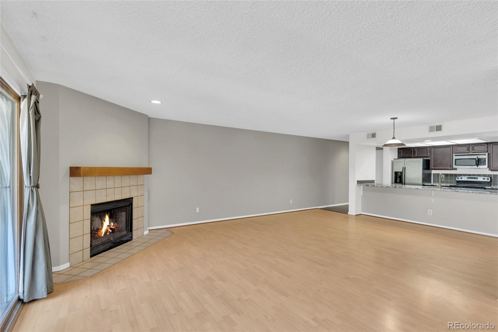 23537 Genesee Village Road Golden, CO 80401 - Photo 12 of 37 a view of a livingroom with an empty space and a fireplace