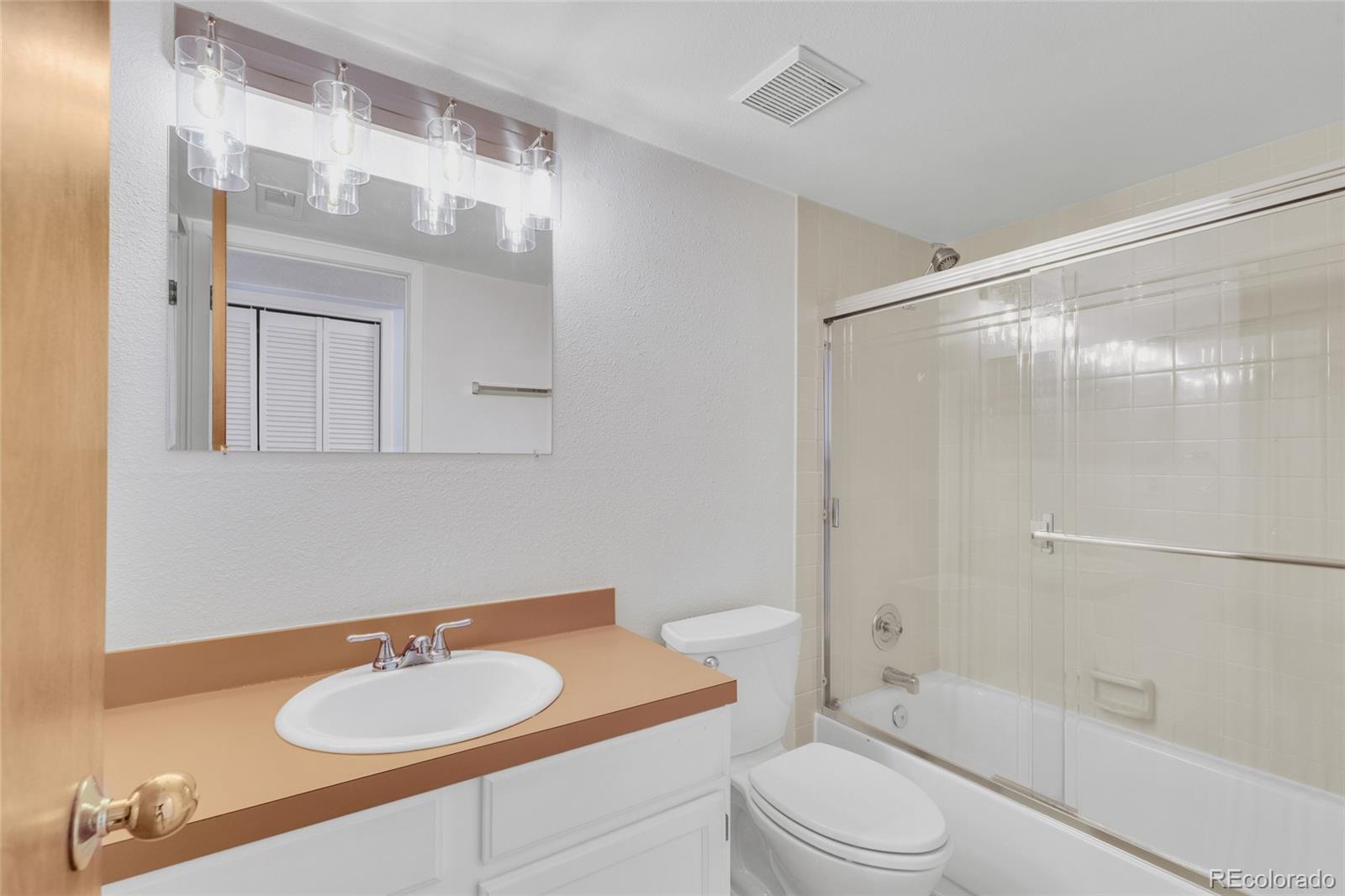 23537 Genesee Village Road Golden, CO 80401 - Photo 20 of 37 a bathroom with a sink toilet and shower