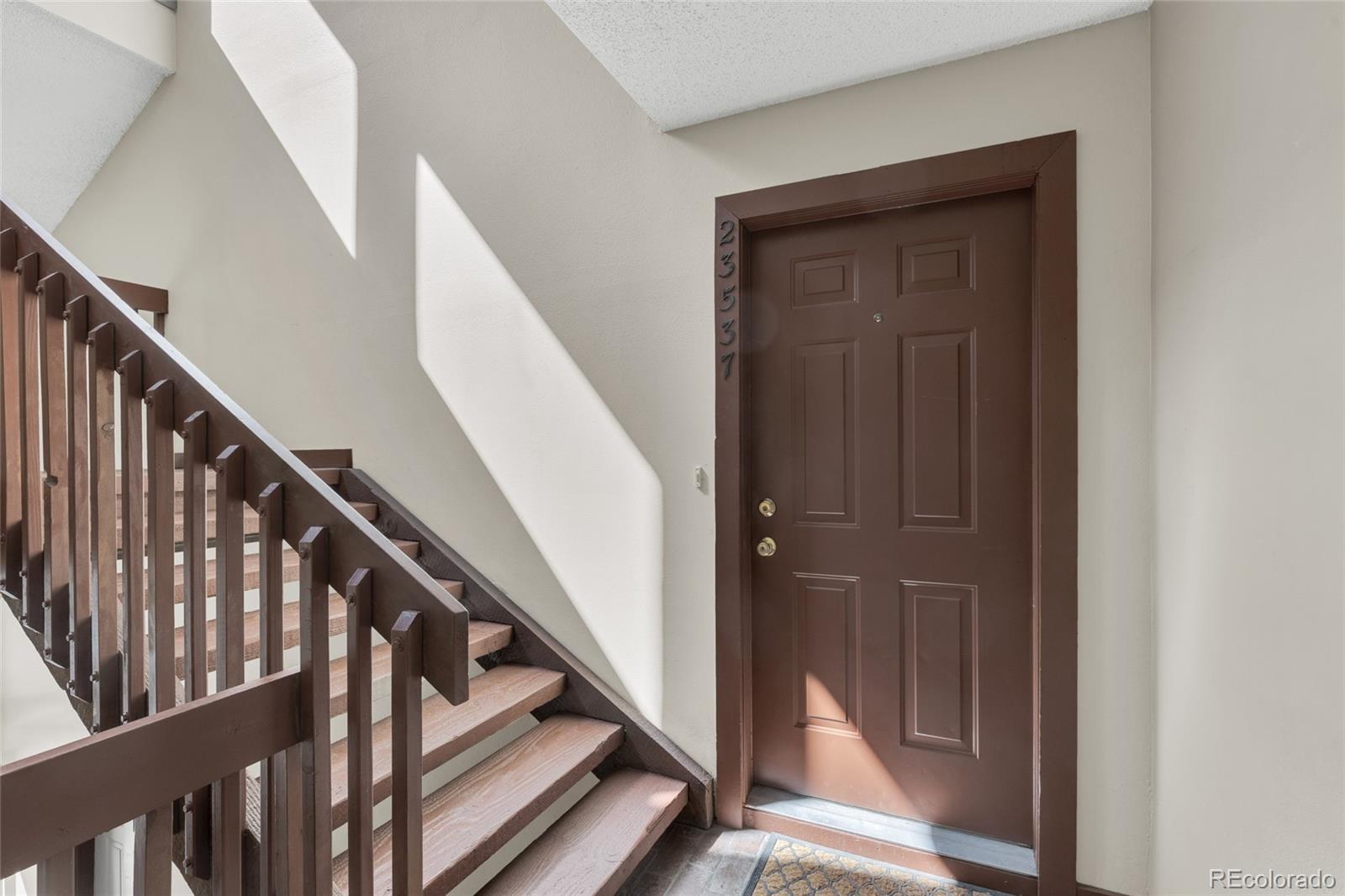 23537 Genesee Village Road Golden, CO 80401 - Photo 22 of 37 a view of staircase with railing and white walls