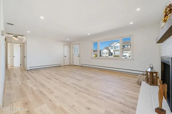 a kitchen with stainless steel appliances granite countertop a sink a stove a dining table and chairs