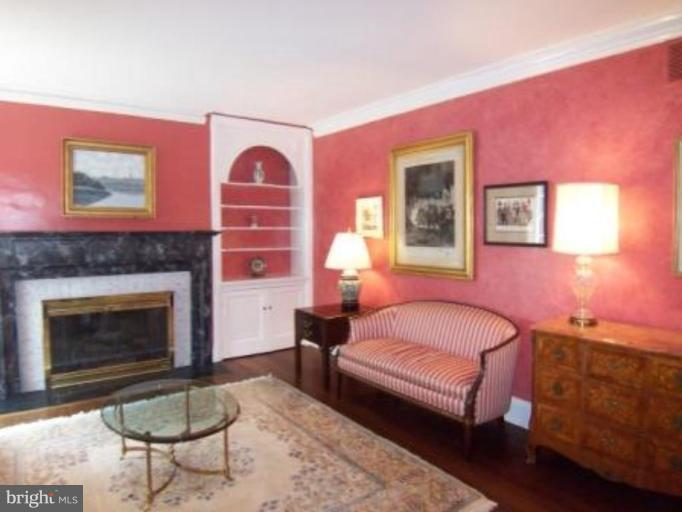 105 Taplow Road Baltimore, MD 21212 - Photo 2 of 14 a bedroom with a bed and a fireplace
