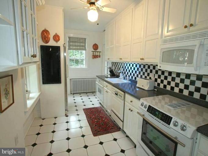 105 Taplow Road Baltimore, MD 21212 - Photo 8 of 14 a kitchen with a stove a sink and a refrigerator