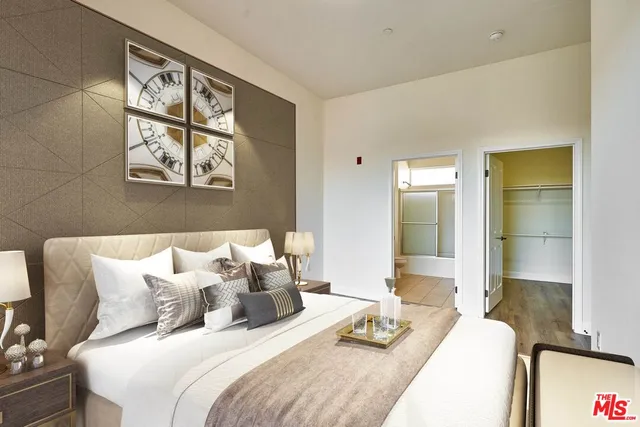 a bedroom with a bed and glass windows