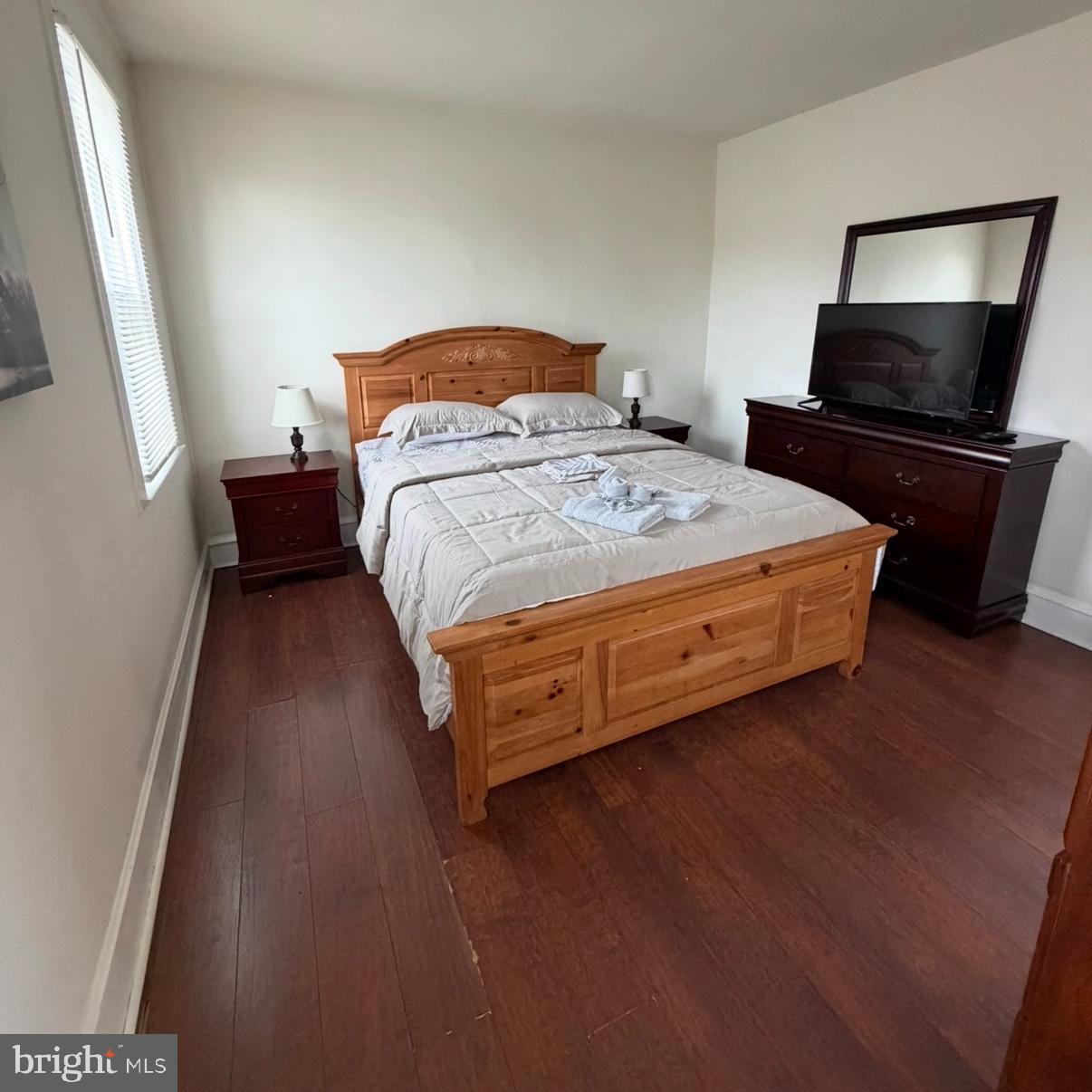 929 Edgemore Road Philadelphia, PA 19151 - Photo 11 of 16 a bedroom with a bed and wooden floor