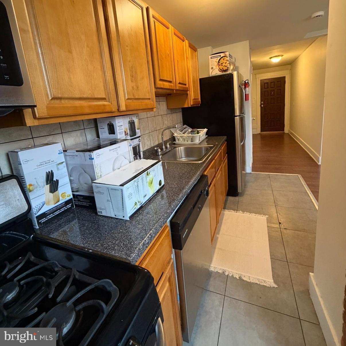 929 Edgemore Road Philadelphia, PA 19151 - Photo 5 of 16 a kitchen with a sink and a stove top oven