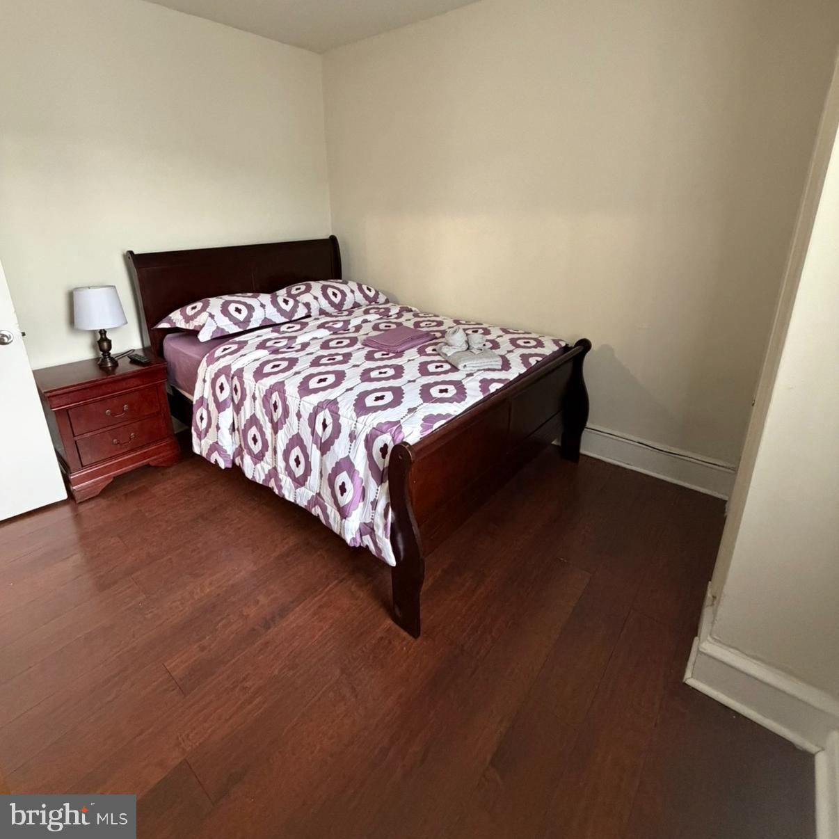 929 Edgemore Road Philadelphia, PA 19151 - Photo 7 of 16 a bed sitting in a bedroom next to a window