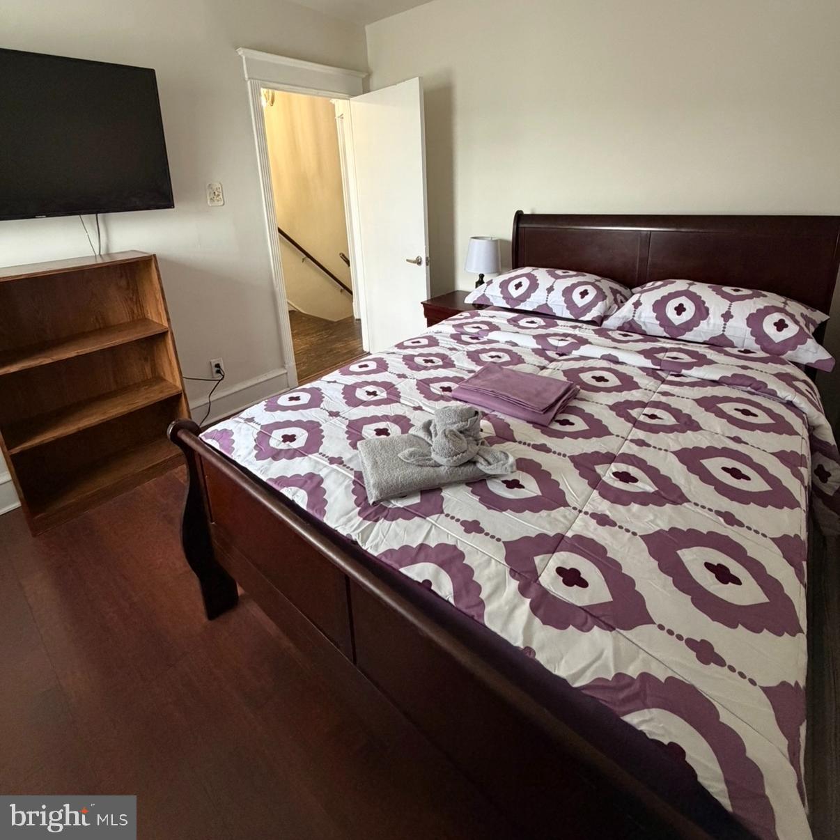 929 Edgemore Road Philadelphia, PA 19151 - Photo 8 of 16 a bedroom with a bed and a flat tv screen on dresser