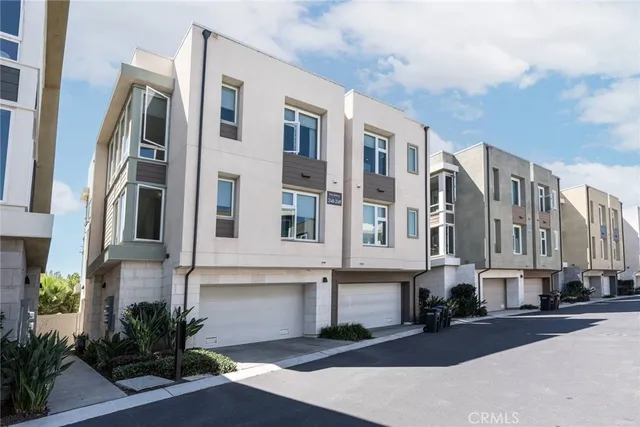 a front view of a multi story residential apartment building with yard
