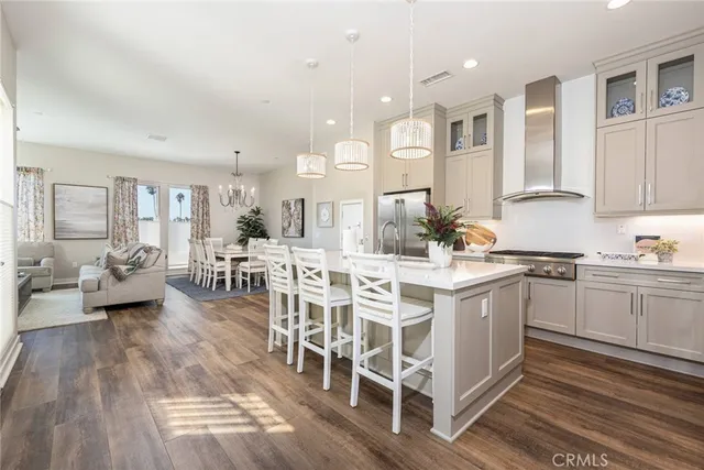 a kitchen with stainless steel appliances kitchen island granite countertop a sink and cabinets