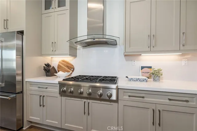 a kitchen with appliances cabinets and a wooden floor