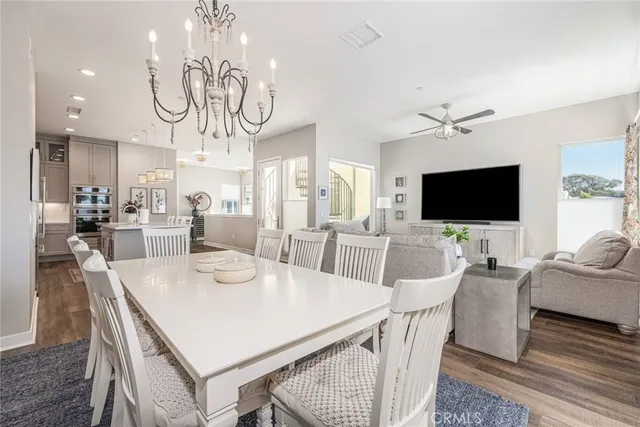a view of a dining room with furniture wooden floor and chandelier
