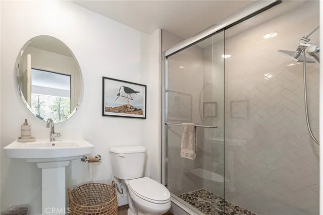 a bathroom with a toilet a sink and shower