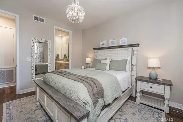 a bedroom with bed and a table with chair