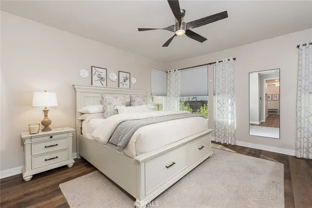 a bedroom with a bed and a lamp on the dresser