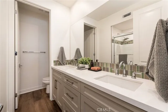 a bathroom with a double vanity sink and a mirror