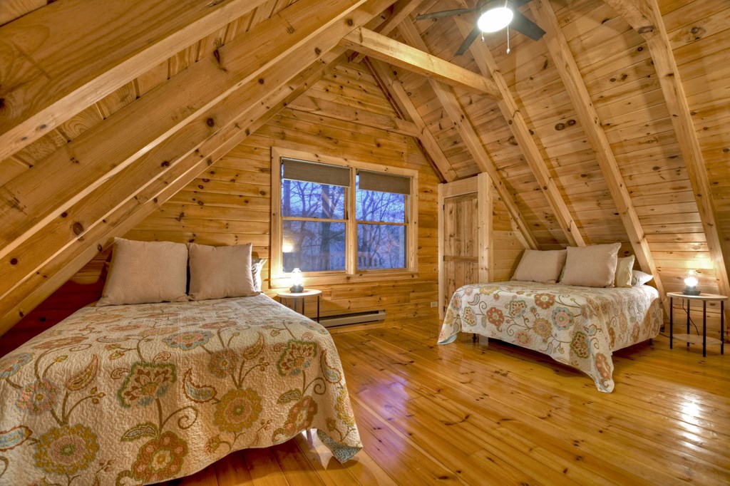 355 Cohutta Mountain Road Blue Ridge, GA 30513 - Photo 17 of 26 a spacious bedroom with a bed and wooden floor
