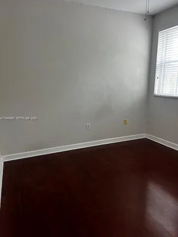 a view of wooden floor and windows in a room