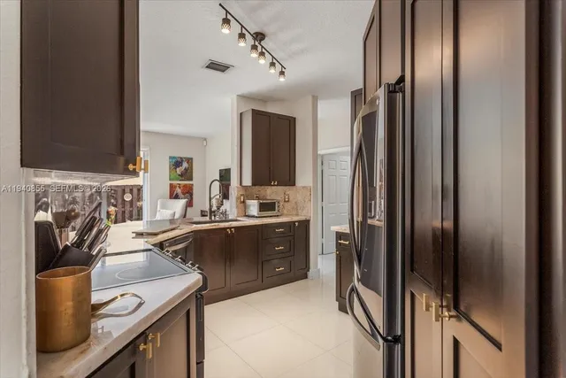 a kitchen with a refrigerator sink and stove