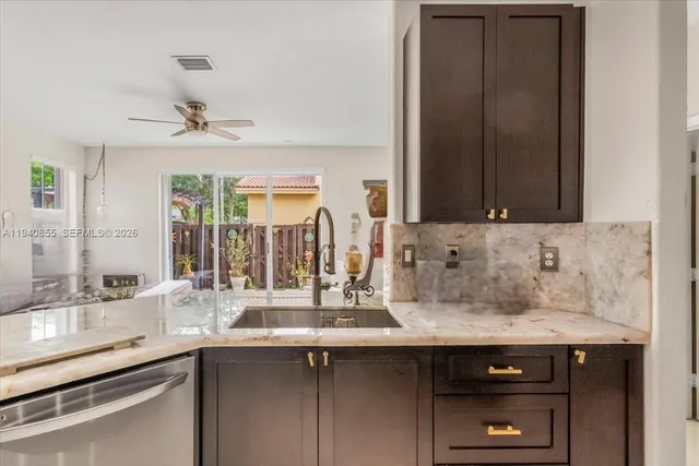 a kitchen with a sink and cabinets