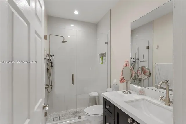 a bathroom with a sink toilet and shower