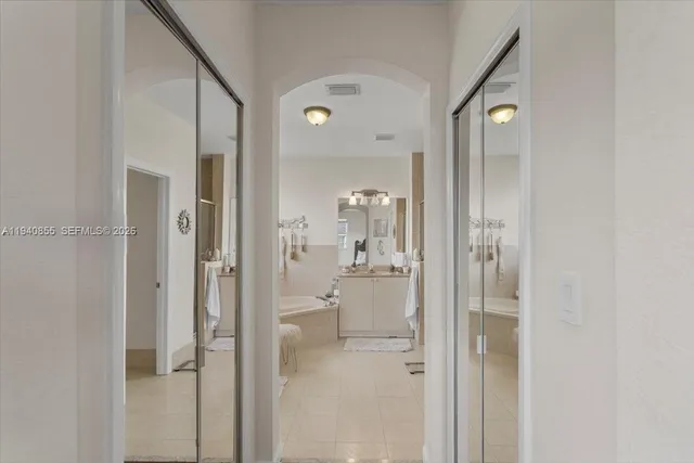 a bathroom with a glass shower door and a mirror