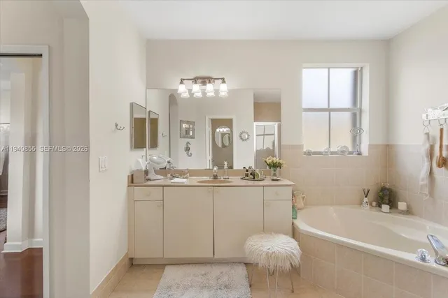 a bathroom with a bathtub a sink and a mirror