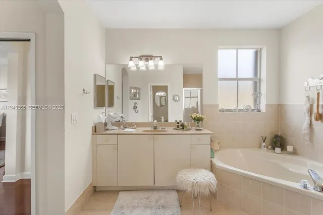 a bathroom with a bathtub a sink and a mirror