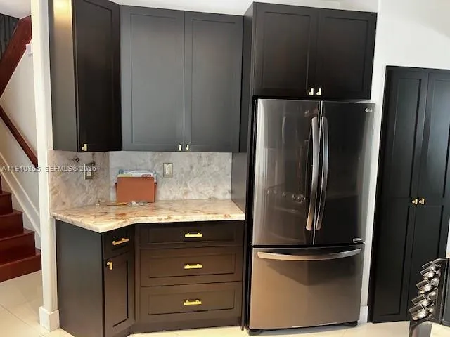 a kitchen with a refrigerator and a sink