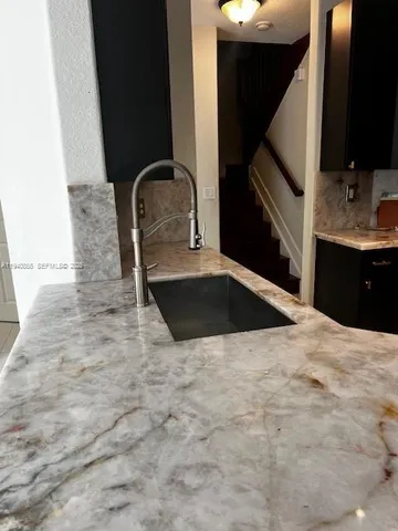 a kitchen with a sink and a stove