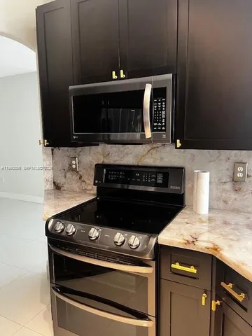 a stove top oven sitting inside of a kitchen