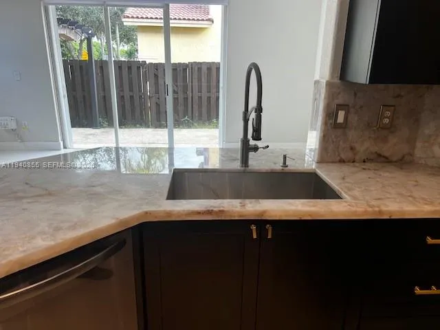 a view of a kitchen counter space and a window