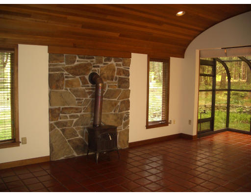 66 South Shaker Road Harvard, MA 01451 - Photo 5 of 26 a view of an empty room with a window and wooden floor