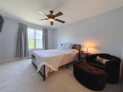 a spacious bedroom with a bed and window