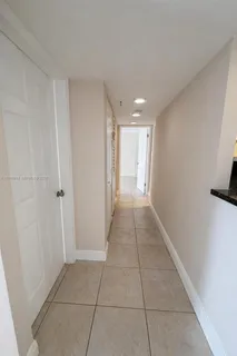a bedroom with a bed and a large window with balcony view