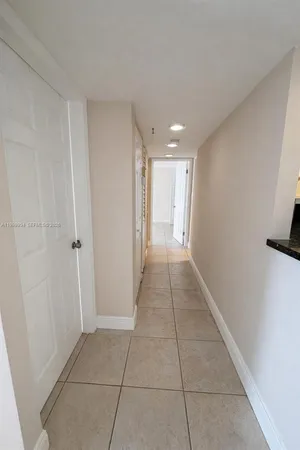 a bedroom with a bed and a large window with balcony view