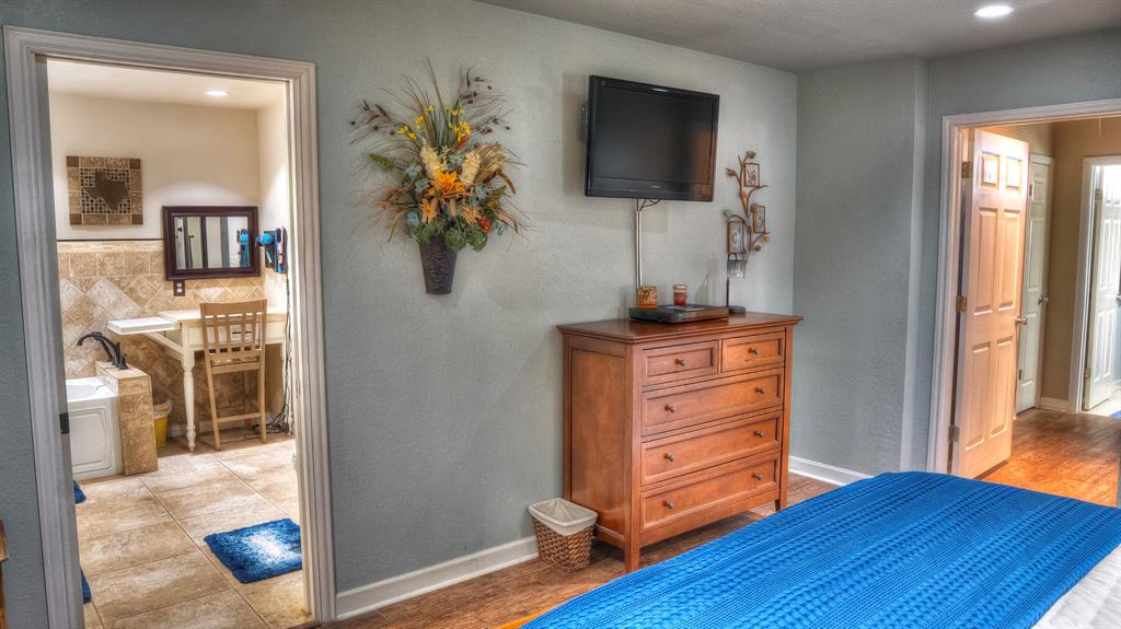 187 Roy Chisum Road Leakey, TX 78873 - Photo 25 of 40 a room with furniture and a flat screen tv