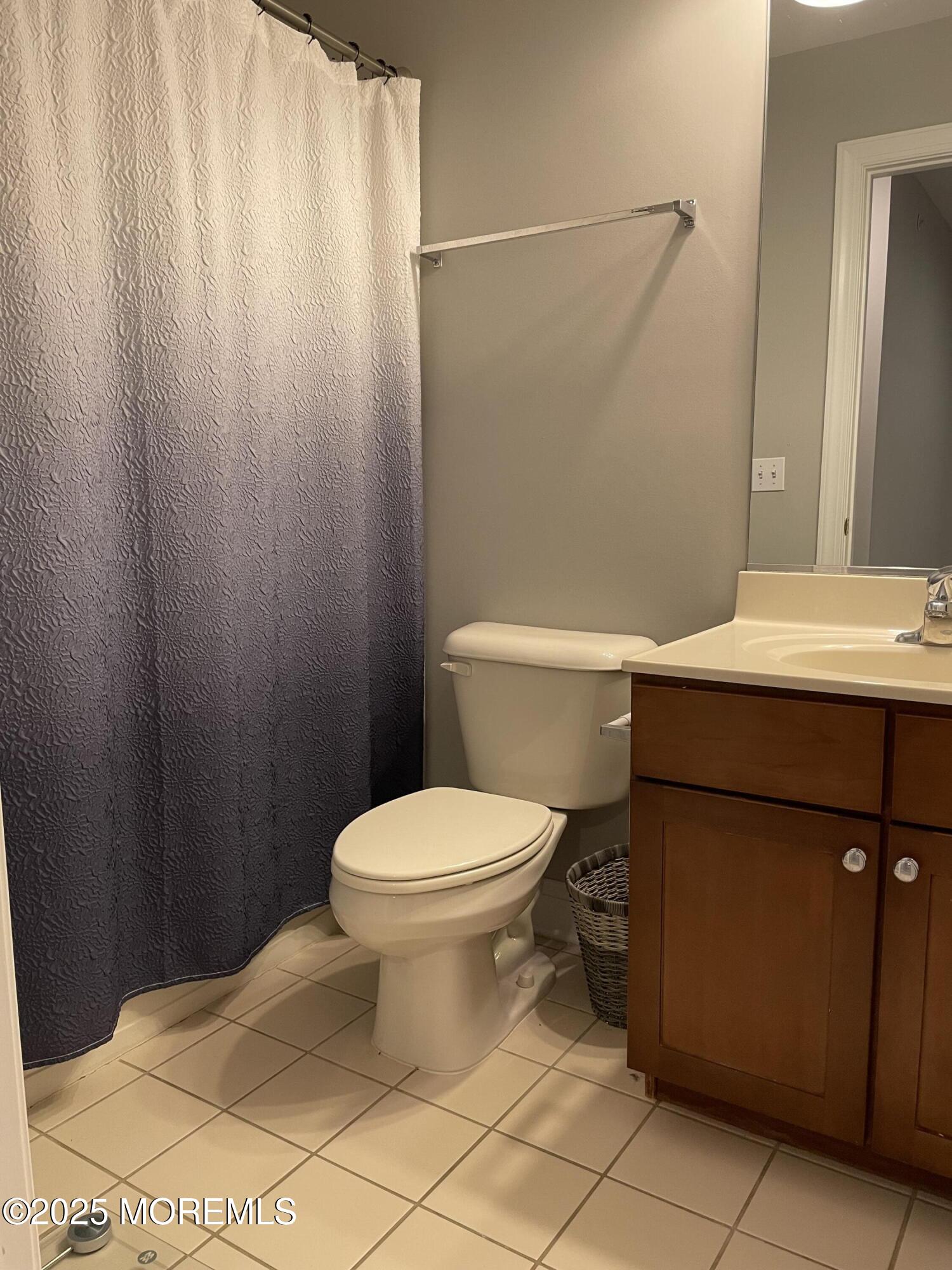 508 Abby Road Middletown, NJ 07748 - Photo 12 of 17 a bathroom with a toilet a sink and vanity
