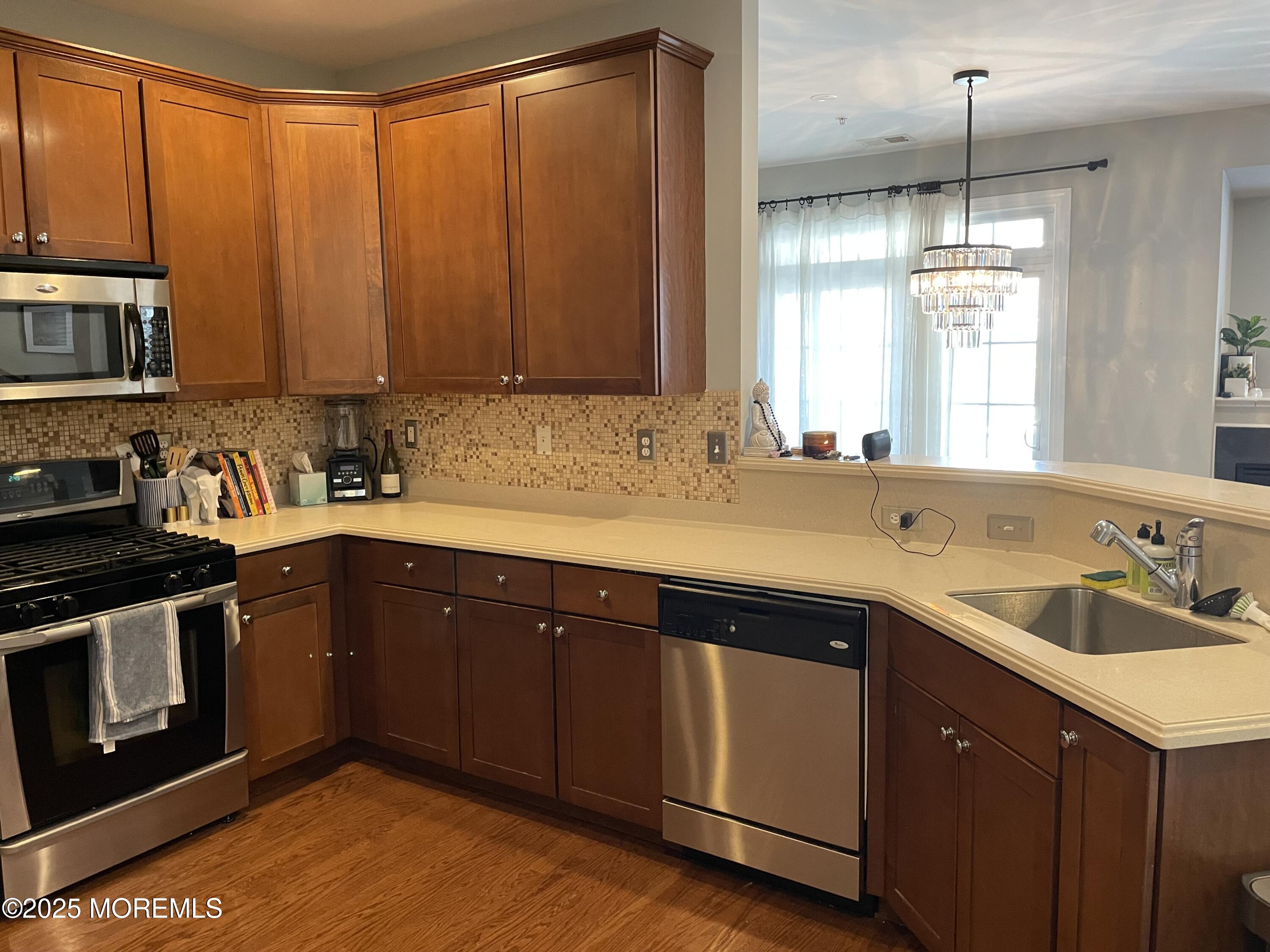 508 Abby Road Middletown, NJ 07748 - Photo 14 of 17 a kitchen with a sink stove and cabinets