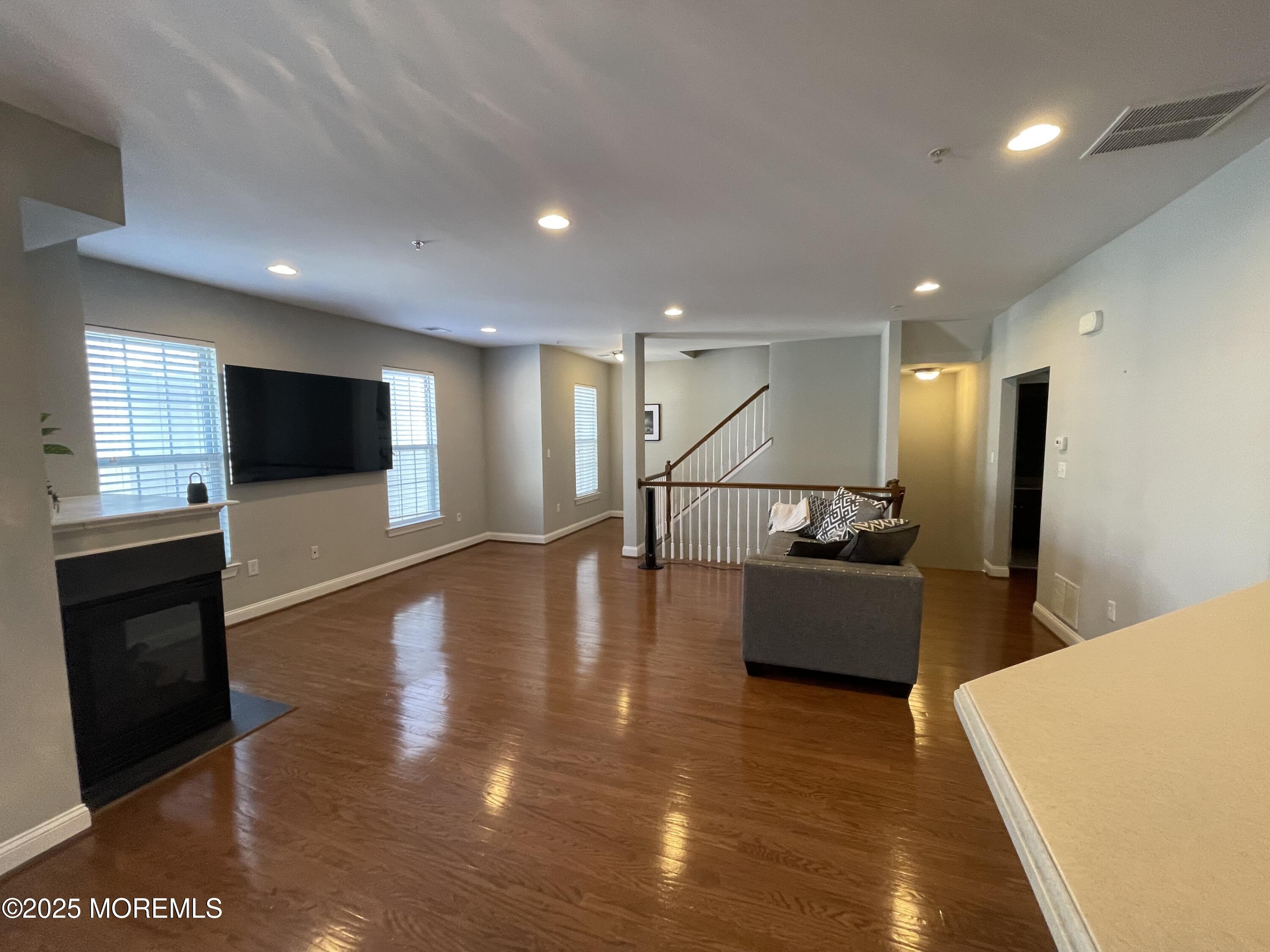508 Abby Road Middletown, NJ 07748 - Photo 16 of 17 a living room with furniture wooden floor and a flat screen tv