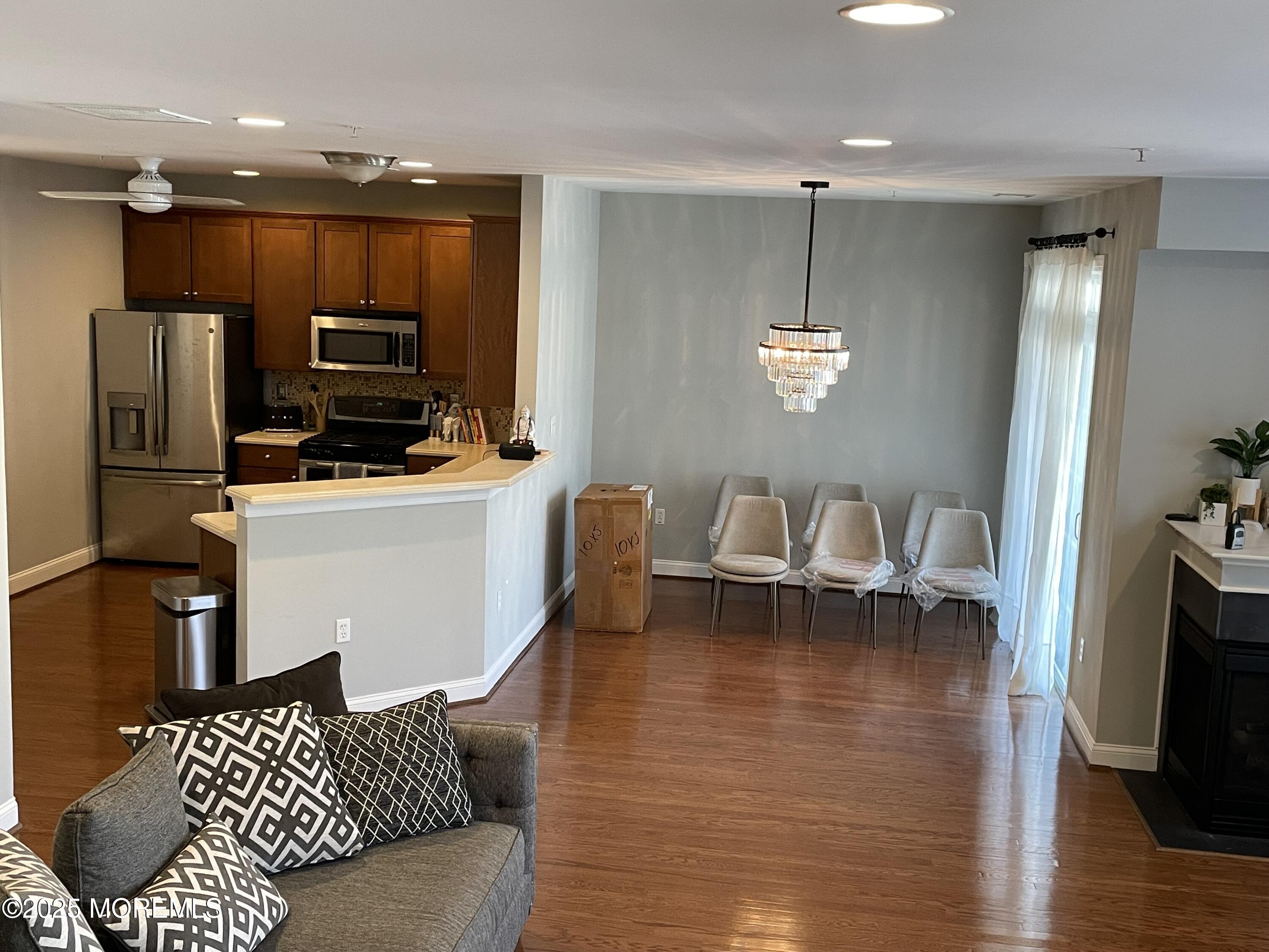 508 Abby Road Middletown, NJ 07748 - Photo 17 of 17 a living room with furniture a flat screen tv and kitchen view