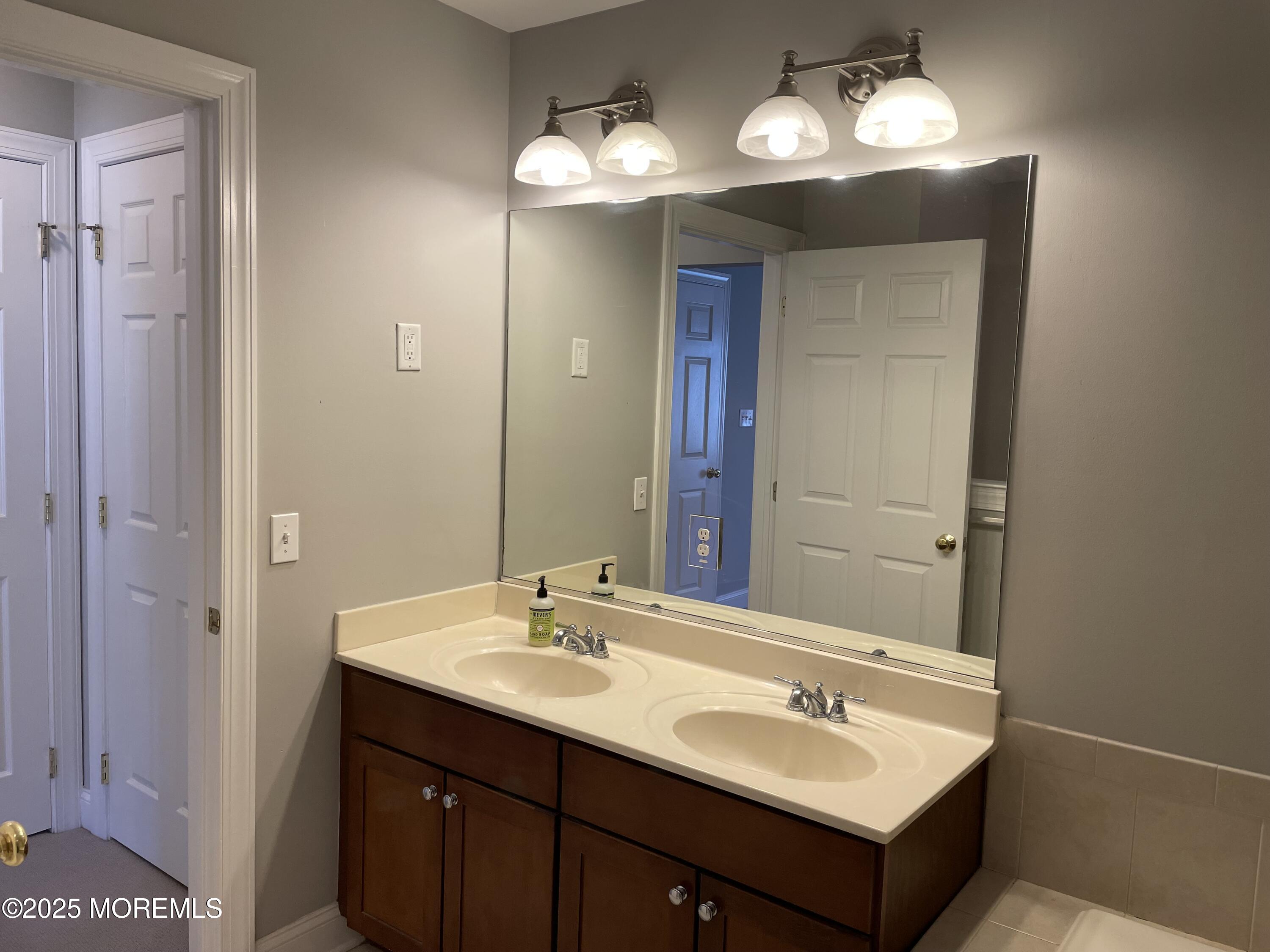 508 Abby Road Middletown, NJ 07748 - Photo 7 of 17 a bathroom with a sink double vanity and a mirror
