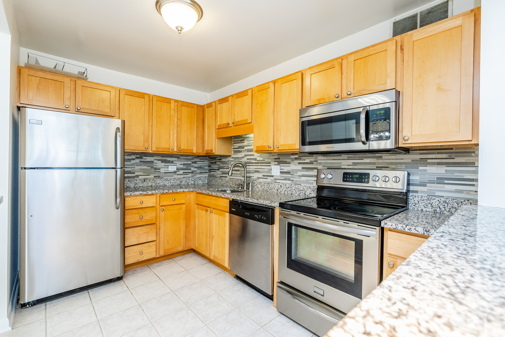 211 East Ohio Street, Unit 2606 Chicago, IL 60611 - Photo 11 of 32 a kitchen with granite countertop cabinets stainless steel appliances and a counter space