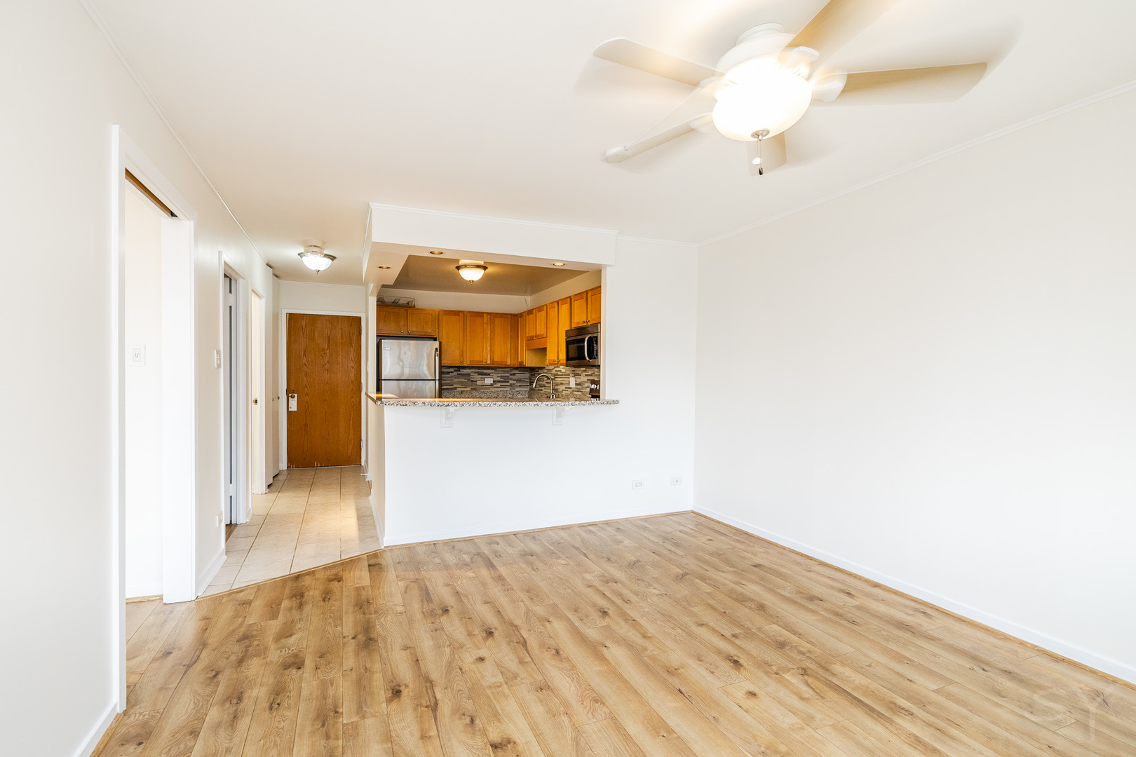 211 East Ohio Street, Unit 2606 Chicago, IL 60611 - Photo 20 of 32 a view of a kitchen cabinets a ceiling fan and wooden floor