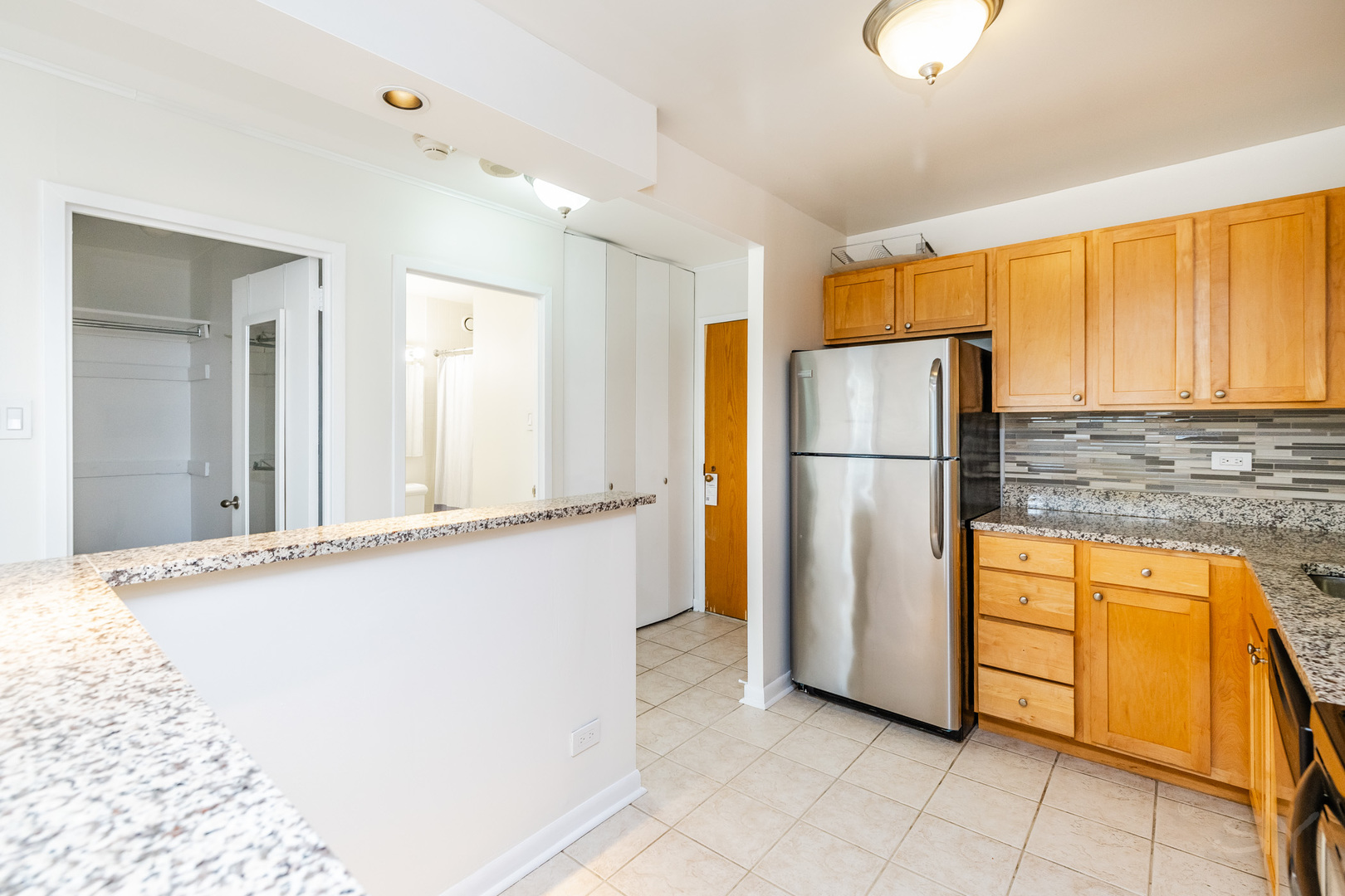 211 East Ohio Street, Unit 2606 Chicago, IL 60611 - Photo 25 of 32 a kitchen with stainless steel appliances granite countertop a refrigerator and a sink