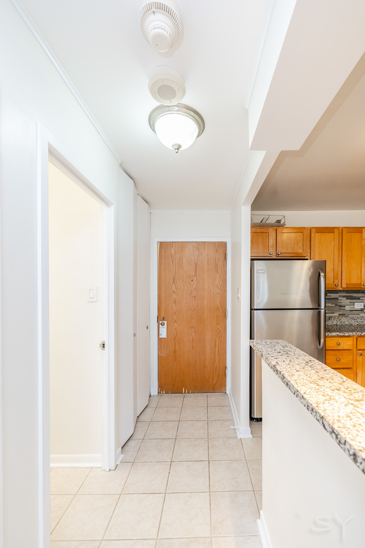 211 East Ohio Street, Unit 2606 Chicago, IL 60611 - Photo 9 of 32 a view of a kitchen with a sink and dishwasher cabinets