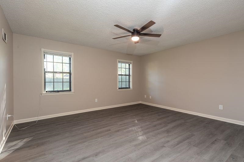 1780 Allenby Road Germantown, TN 38139 - Photo 14 of 26 a view of an empty room with wooden floor and a window