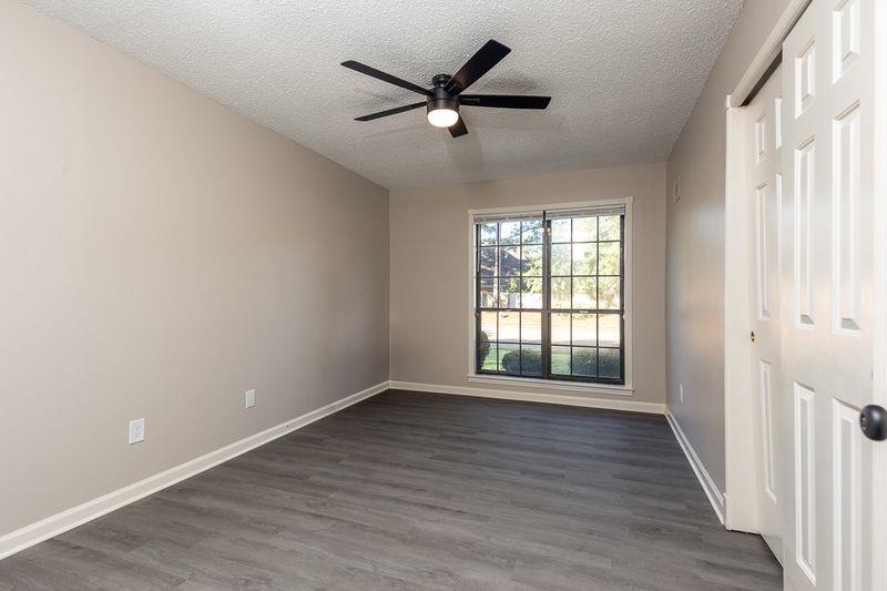 1780 Allenby Road Germantown, TN 38139 - Photo 17 of 26 a view of an empty room with a window and wooden floor
