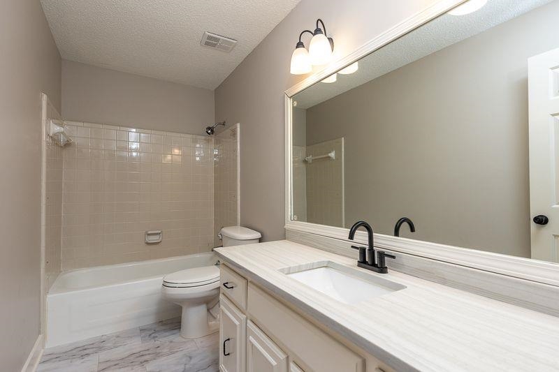1780 Allenby Road Germantown, TN 38139 - Photo 19 of 26 a bathroom with a sink a toilet and shower