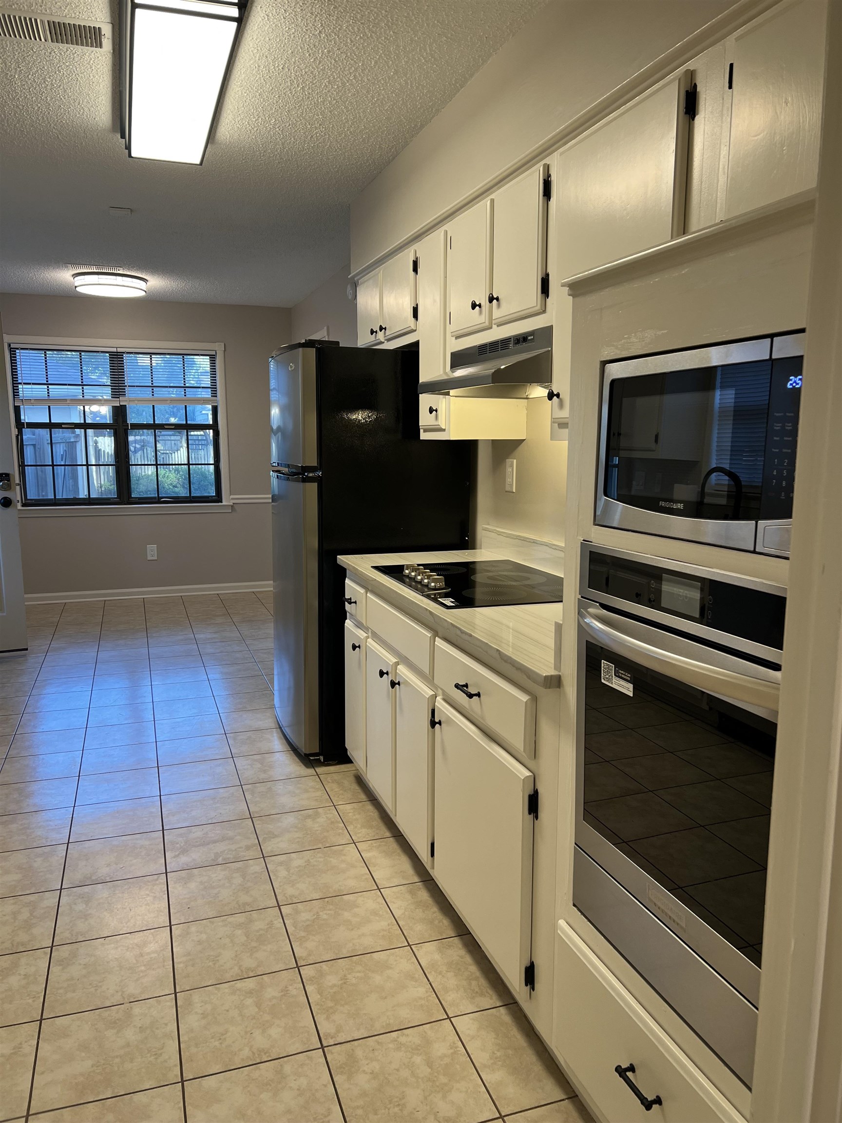 1780 Allenby Road Germantown, TN 38139 - Photo 26 of 26 a kitchen with stainless steel appliances a stove a microwave and white cabinets