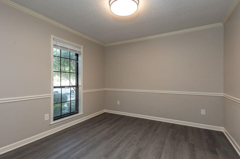 1780 Allenby Road Germantown, TN 38139 - Photo 5 of 26 an empty room with wooden floor and windows